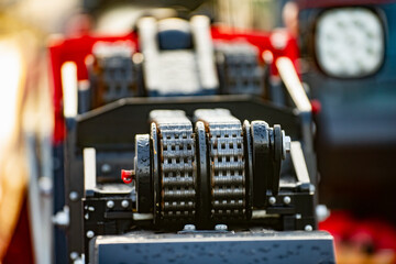 Industrial telescopic telehandler lift mast chain mechanism close up.