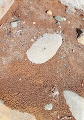 saw the surface of brown sand and stones on the river bank
