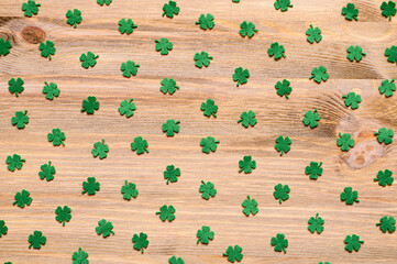 St Patricks Day background with green quatrefoils on the wooden background