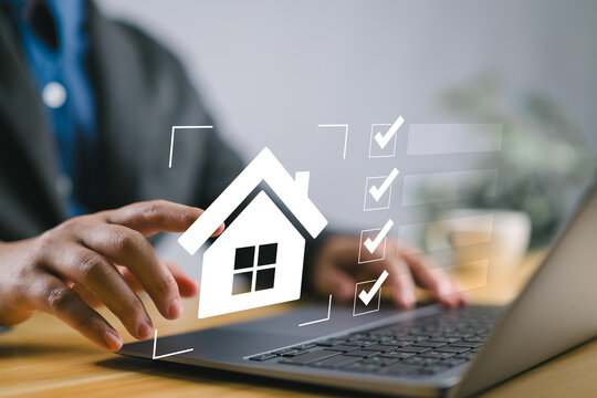 Real estate checklist concept, Businessman organizing real estate tasks on a laptop using a digital checklist, streamlining property management and housing investments with innovative tools.