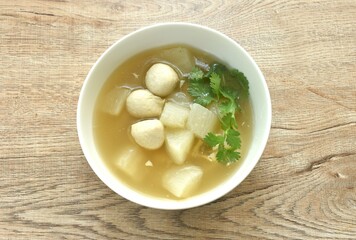 boiled slice radish with pork ball in clear bone soup on bowl