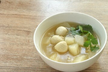 boiled slice radish with pork ball in clear bone soup on bowl