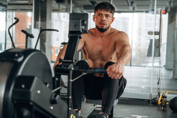 Obraz premium Preparing, doing cardio. Man is in the modern gym
