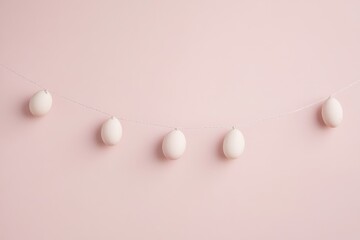 Minimalist easter decoration with white eggs hanging on pink background