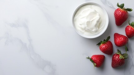A bowl of yogurt and strawberries on a white counter