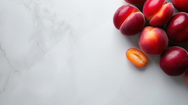 A close up of a bunch of red plums with one of them cut in half - Powered by Adobe