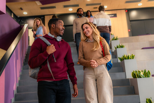 University students walking down stairs and talking