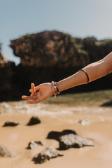 Close up of Indian woman's hands in traditional jewelry on the nature. Indian festival costume. Concept of solo tourism and travel to India
