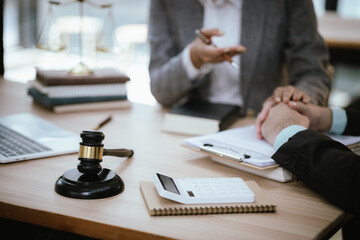 Lawyer Legal counsel presents to the client a signed contract with gavel and legal law. justice and lawyer Business partnership meeting concept.