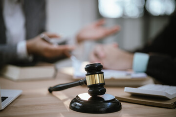 Lawyer Legal counsel presents to the client a signed contract with gavel and legal law. justice and lawyer Business partnership meeting concept.