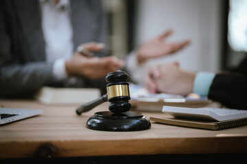 Lawyer Legal counsel presents to the client a signed contract with gavel and legal law. justice and lawyer Business partnership meeting concept.