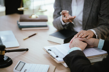 Lawyer Legal counsel presents to the client a signed contract with gavel and legal law. justice and lawyer Business partnership meeting concept.