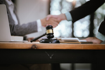 Lawyer Legal counsel presents to the client a signed contract with gavel and legal law. justice and lawyer Business partnership meeting concept.