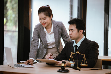 Lawyer Legal counsel presents to the client a signed contract with gavel and legal law. justice and lawyer Business partnership meeting concept.