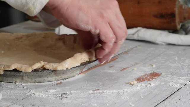 Baking a pecan pie in a rustic kitchen using a 100 year old recipe loaded with pecans and a home made crust. Delicious homemade pecan pie.