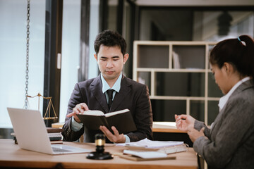 Lawyer Legal counsel presents to the client a signed contract with gavel and legal law. justice and lawyer Business partnership meeting concept.