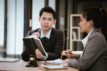 Lawyer Legal counsel presents to the client a signed contract with gavel and legal law. justice and lawyer Business partnership meeting concept.