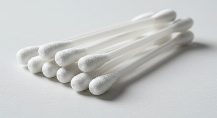 Pile of White Cotton Swabs on White Background