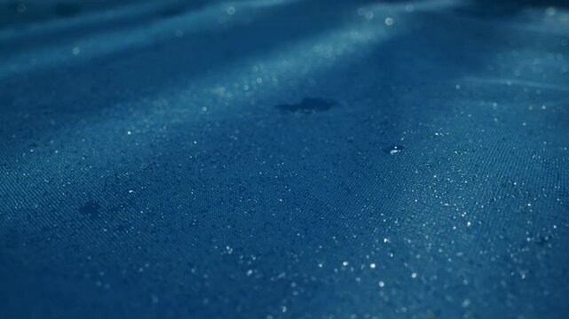 Tranquil Water Surface with Raindrops in Beautiful Blue Hues Captivating the Mind