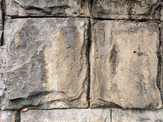 An aged stone wall creates a textured, rustic background with weathered stones and a timeless feel.