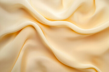 Fototapeta premium Soft, flowing fabric in pale yellow draped elegantly, creating a serene and calming background
