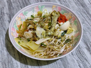 Soto Ayam in Indonesia. Soto ayam is a traditional Indonesian dish that uses ingredients such as shredded chicken, potatoes, eggs, rice vermicelli, bean sprouts with a delicious sauce.