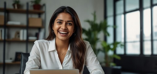 Enthusiastic businesswoman, Indian professional, smiling with happiness while working on her laptop