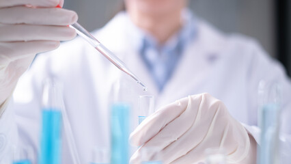 Close-up scientist pipette drop to test tube laboratory research chemistry chemical science research
