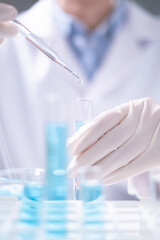 Fototapeta premium Close-up scientist pipette drop to test tube laboratory research chemistry chemical science research