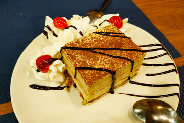 Decadent Tiramisu Dessert with Whipped Cream and Cherries for Gourmet Dining