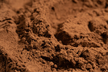 Cocoa powder pile close-up, rotation. Pastry chef. Brown cocoa powder texture circle rotation close-up. Chocolate	
