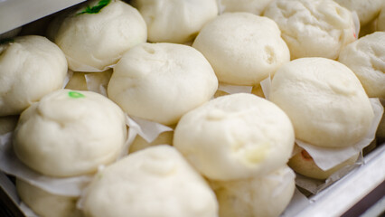 A stack of fresh steamed buns fresh from the oven