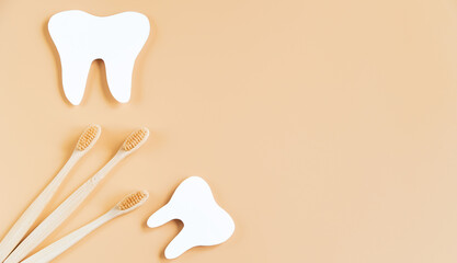 Eco-friendly wooden toothbrushes on trendy beige background. Dental care concept. Happy dentist day. Greeting card. Banner format.