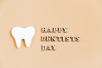 International Dentist Day. Happy dentists day. Eco-friendly wooden toothbrushes on trendy beige background. Dental care concept. Greeting card.