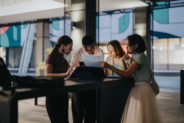 A diverse group of business professionals working together on a project in a modern urban environment, showcasing teamwork and collaboration. The image highlights the dynamic nature of international