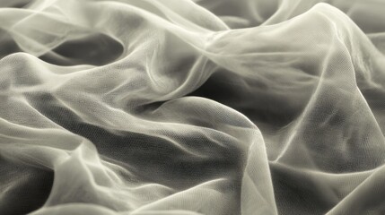Obraz premium A close-up of soft, delicate tulle fabric in various shades of grey and white, creating an ethereal texture that captures the essence of lightness and airiness.