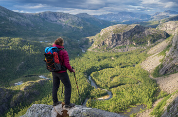 Hiker looking over the valley in National Park Rago, Norway.