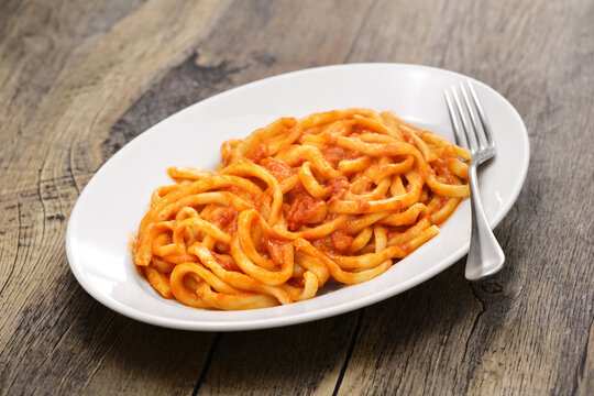 Pici all'aglione, a Sienese specialty, thick handmade pasta with garlic tomato sauce.