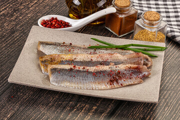 Salted marinated herring fillet with spices