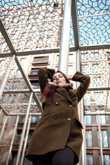 Businesswoman relaxing under modern architecture canopy