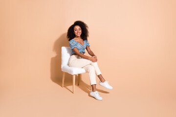 Full length photo of shiny attractive lady dressed blue blouse sitting chair empty space isolated...