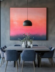 Pink and navy blue painting above table and grey chairs in dining room interior. Real photo