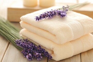 A spa setting offering complimentary services, with warm tones of beige towels and lavender sprigs on a wooden table