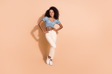 Full length photo of charming positive woman wear blue top smiling empty space isolated beige color background