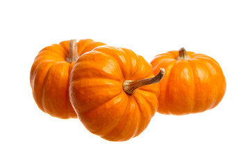 Three vibrant orange pumpkins with glossy surfaces and stems, isolated on a white background. Perfect for autumn, Halloween, and Thanksgiving decorations