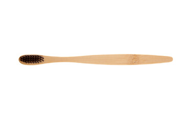 Sustainable bamboo toothbrush with a smooth wooden handle and black bristles, isolated on a white background. Ideal for eco-friendly and zero-waste oral care