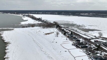 Lake Ontario coastline in Winter with snow and ice after deep freeze weather conditions at Irondquoit Bay new Rochester, NY