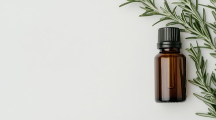 Top view of a rosemary essential oil bottle alongside vibrant green sprigs on a clean white surface, highlighting natural beauty