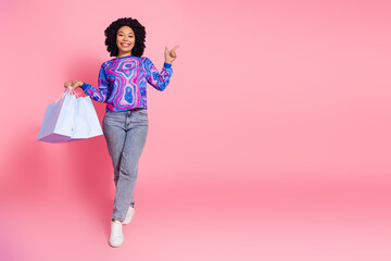Photo of lovely cute woman wear trendy clothes hold packages recommend empty space isolated on pink...