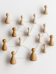 Obraz premium Network concept with wooden figures connected on a white surface symbolizing human resources strategy and management